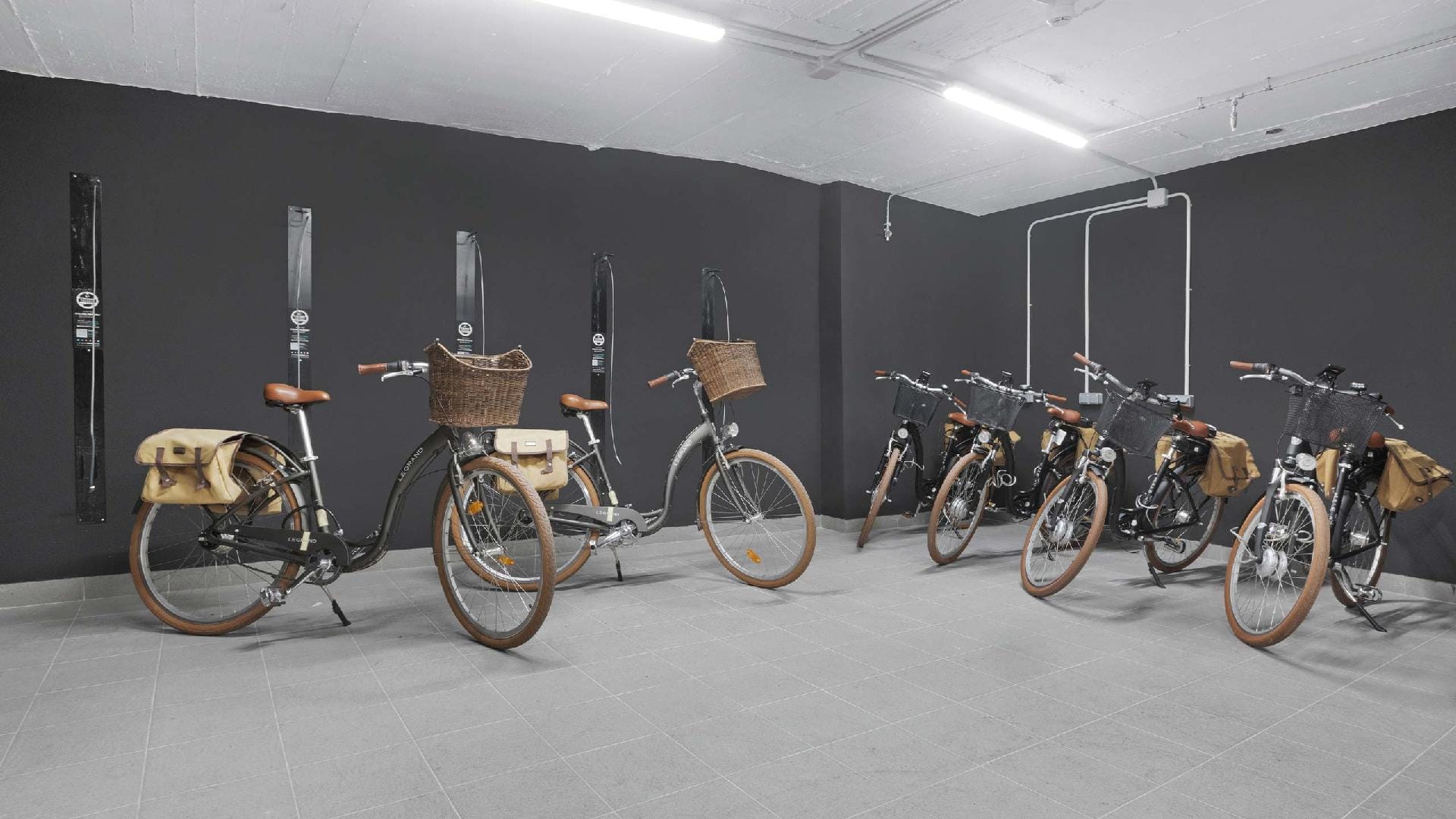 Hotel room with leisure bicycles, some electric, with baskets and panniers